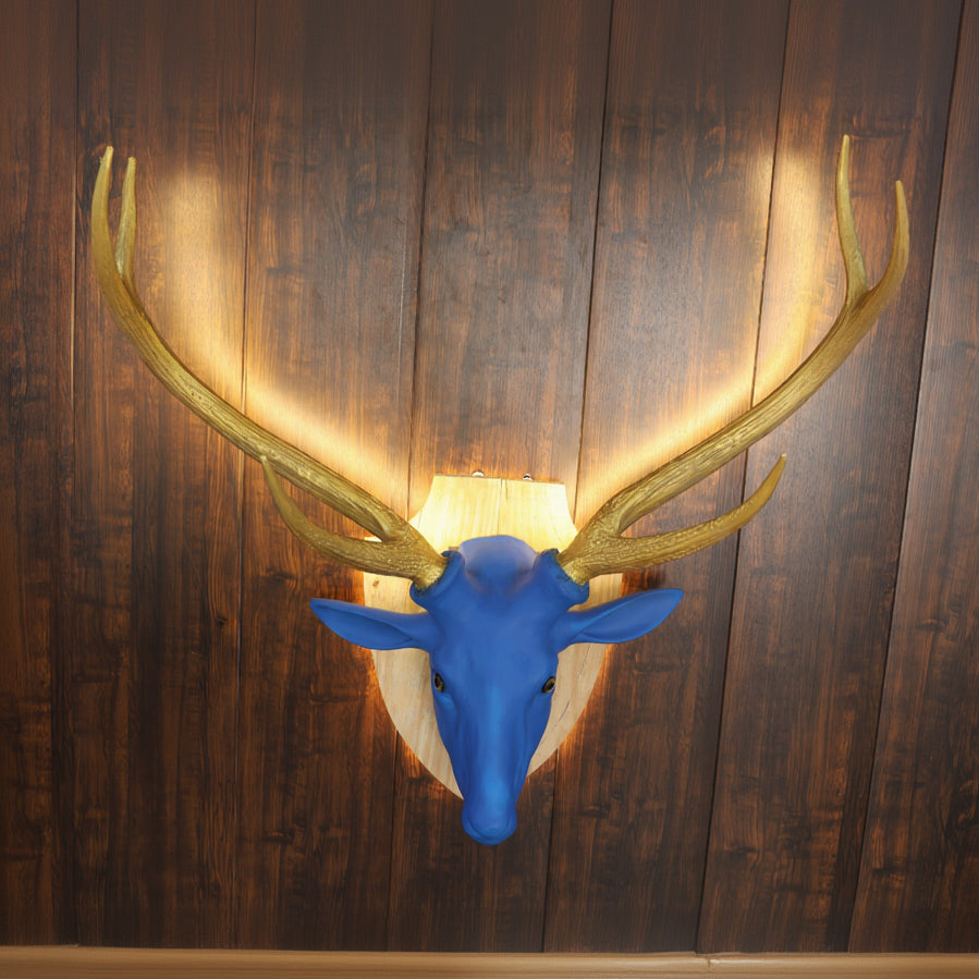 Blue deer head mount with gold antlers on a wooden wall