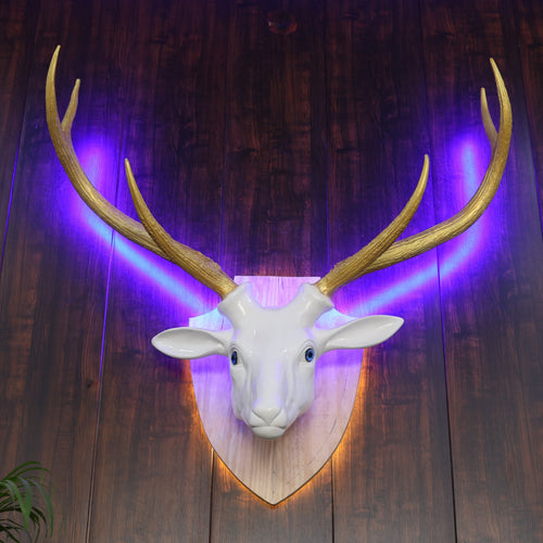 Deer head mount on a wooden wall with purple lighting